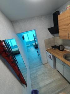 a small kitchen with a staircase leading into a room at Silver 2 Затока in Zatoka +6 photos