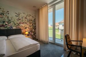 um quarto com uma cama com uma parede floral em Dvorec Gregorčič em Smarjeske Toplice