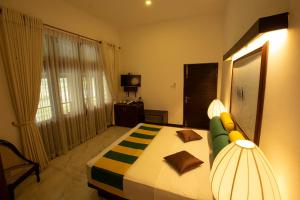 1 dormitorio con 1 cama y TV en Huluganga Ridge, Kandy en Kandy