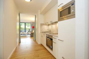 a kitchen with a sink and a microwave at Papillon Wohnung 08-1 in Boltenhagen