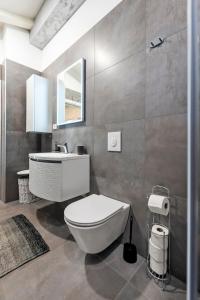 a bathroom with a white toilet and a sink at Apartment Arian in Rovinj