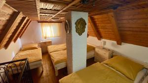 a room with two beds in a room with wooden walls at Chata Ben in Chotěboř