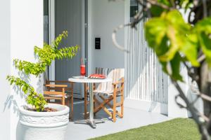 a patio with a table and chairs on a balcony at Blue Harbour Boutique in Ayia Napa