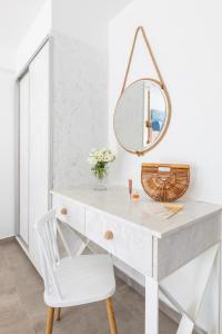 a white desk with a mirror and a chair at Blue Harbour Boutique in Ayia Napa