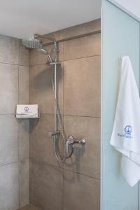 a shower with a shower head in a bathroom at Blue Harbour Boutique in Ayia Napa