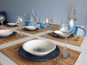 a table with wine glasses and a bowl on a table at Amplio Adosado 160 m, jardín privado barbacoa, vistas al mar, wifi 7 px mascotas in Peñíscola