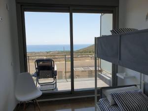 a bedroom with a bed and a view of the ocean at Amplio Adosado 160 m, jardín privado barbacoa, vistas al mar, wifi 7 px mascotas in Peñíscola +89 photos