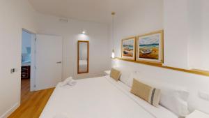 Кровать или кровати в номере Apartamentos La Casa El Palo