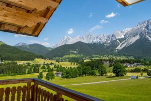 a view of the mountains from the balcony of a house at Alpin Residenz Dachsteinperle in Ramsau am Dachstein