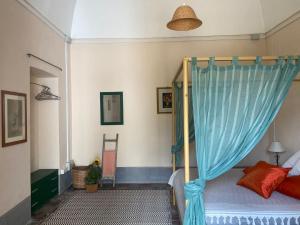 a bedroom with a bed with a blue curtain at Agriturismo Tenuta Muzio in Sannicola