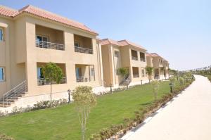 a row of houses with a green lawn at Tolip El Fairouz Hotel in Ismailia