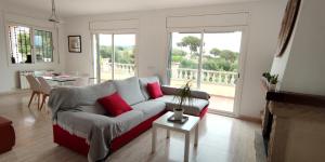 a living room with a couch and a table at Villa Fradera in Lloret de Mar