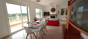 uma sala de estar com uma mesa e cadeiras e um sofá em Villa Fradera em Lloret de Mar