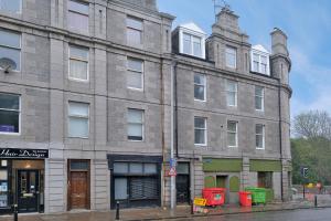 a large brick building on the corner of a street at Central Aberdeen Apartment in Aberdeen