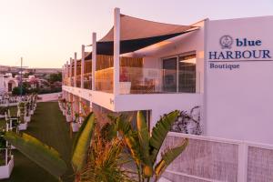 a building with a balcony with a sign that reads blue harbour boutique at Blue Harbour Boutique in Ayia Napa