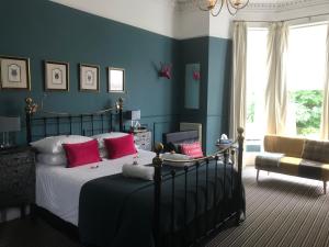 a bedroom with a bed with red pillows at Albyn Townhouse in Edinburgh