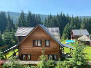 a log cabin in the middle of a forest at Cottage Karinka in Bukovel
