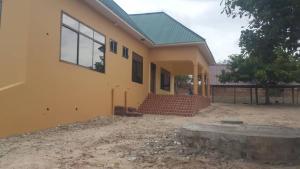 a house is being built with a yard at Farmhouse Lodge in Dar es Salaam