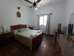Un pat sau paturi într-o cameră la Casa Cafayate