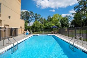 a swimming pool with blue water in a building at Comfort Inn Birmingham - Irondale in Birmingham