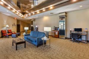 a lobby with a blue chair and a desk at Comfort Inn Alliance in Alliance