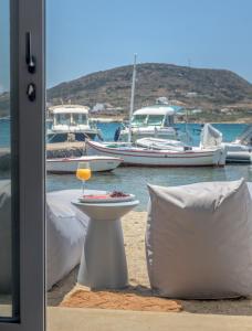 a plate of food on the beach with boats in the water at Michalakis Seaside Suites in Pollonia
