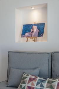 a picture on the wall above a couch at Michalakis Seaside Suites in Pollonia
