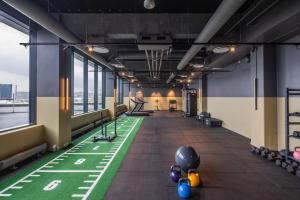 a gym with a green floor and treadmills at Comfort Hotel Copenhagen Airport in Copenhagen
