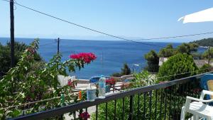 a balcony with a view of the ocean at Stafylos Rooms in Stafylos