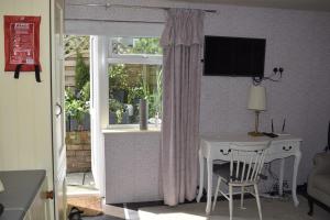 a room with a desk and a window with a table at Cosy self-contained studio flat in Bristol in Bristol