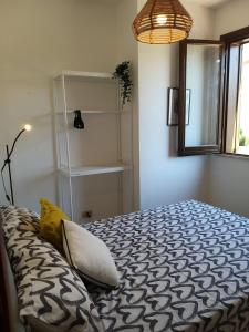 a bedroom with a bed with a pillow and a window at IL VIAGGIO DI COSIMO in San Vito lo Capo