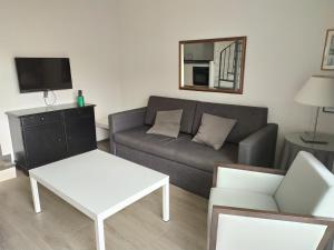 a living room with a couch and a table at Apartamentos HG Cristian Sur in Los Cristianos