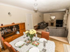 a living room with a table with flowers on it at Spring Close in Southport