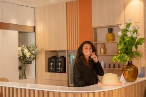a woman is standing in front of a mirror at ibis Styles Beaulieu sur Mer in Beaulieu-sur-Mer