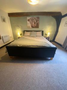 a bedroom with a large bed with two lamps at Charles I 16th century house in Newark-on-Trent