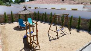 two chairs and a swing set in the sand at LA CASONA DE MANUELA in San Benito de la Contienda