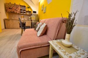 a living room with a pink couch and a table at KRAN Studio in Sibiu +7 photos