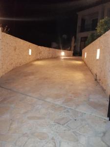 an empty patio at night with lights on it at Villa Clio in Mánganos