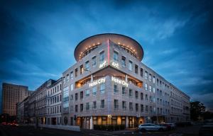 a large building with a dome on top of it at Art Hotel City Leipzig in Leipzig