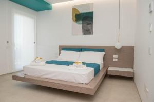 Postel nebo postele na pokoji v ubytování Il Faraglione - Suite di Charme