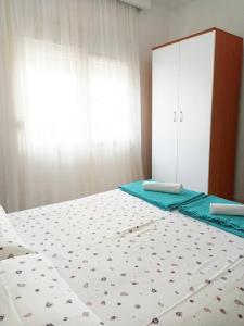 a bedroom with two beds and a dresser at Mediteraneo Apartments in Budva