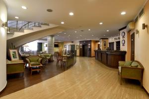 a lobby of a hospital with chairs and tables at Voznesensky Hotel in Yekaterinburg