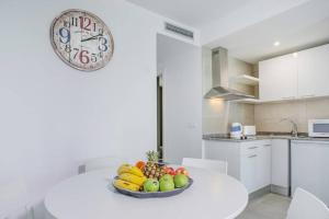 a bowl of fruit on a white table in a kitchen at Aldara Home by Best Holidays Fuerteventura in Corralejo