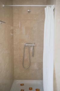 a shower with a shower curtain in a bathroom at Sea Breeze - BeachHouse in Mindelo