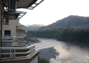 a view of a river from a building at Sangam Hotel Muzaffarabad in Muzaffarabad