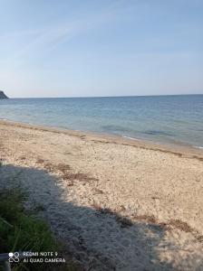 a sandy beach with the ocean in the background at Sunset Apartment in Epanomi