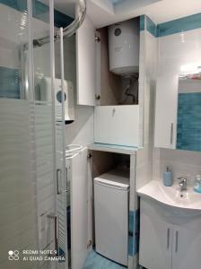 a bathroom with a shower and a toilet and a sink at Sunset Apartment in Epanomi +37 photos