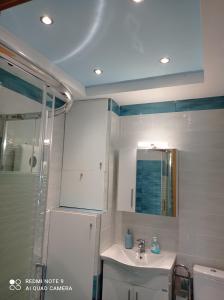 a bathroom with a sink and a shower and a toilet at Sunset Apartment in Epanomi