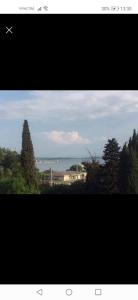 a view of the ocean with a plane flying in the sky at Sunrise Apartment in Burgas