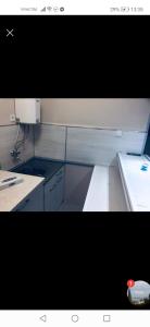 a kitchen with white counters and a counter top at Sunrise Apartment in Burgas